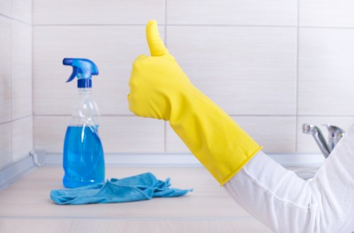 Office cleaning team in Kingston disinfecting desks and shared surfaces