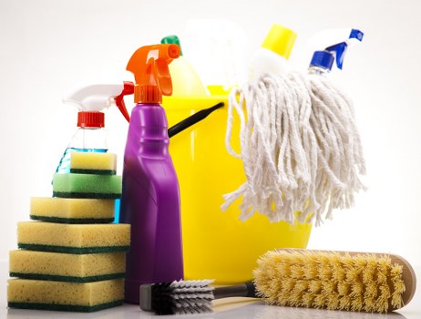 Cleaner wearing PPE while following safe working practices